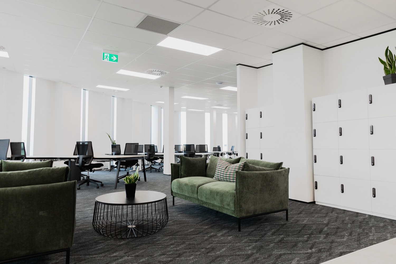 Member lounge with green sofas